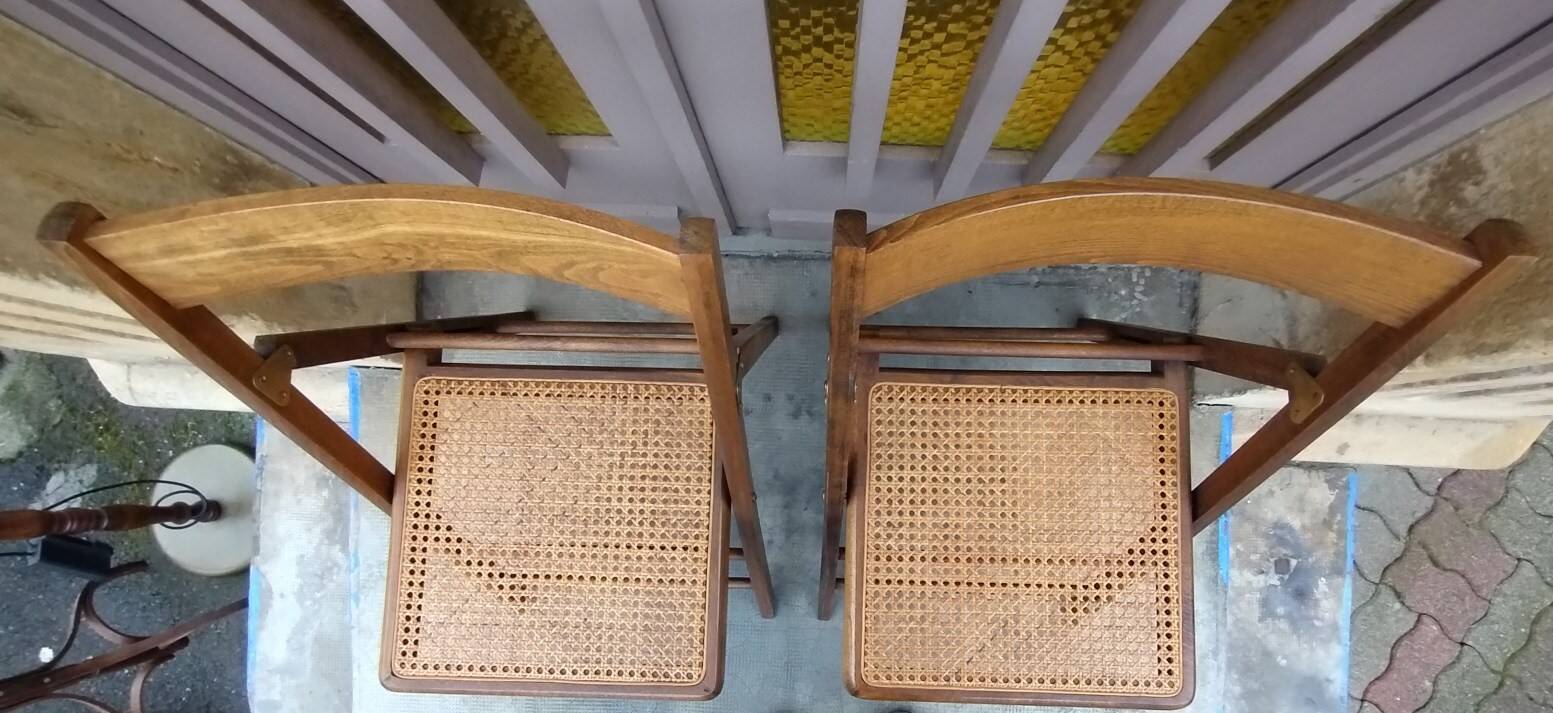 Pair of vintage wooden and cane folding chairs
