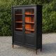 Renovated black antique Louis XVI style display cabinet, glass-fronted bookcase.
