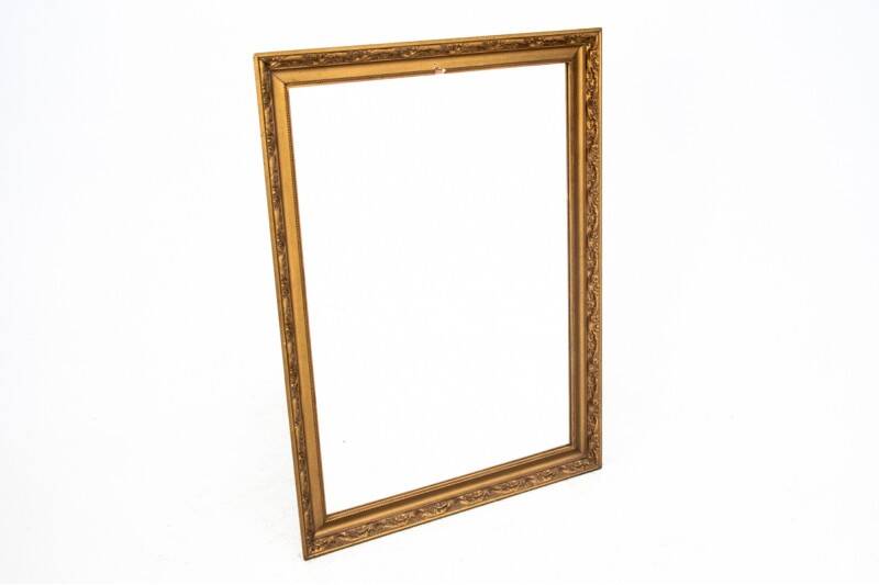 A mirror in a golden frame