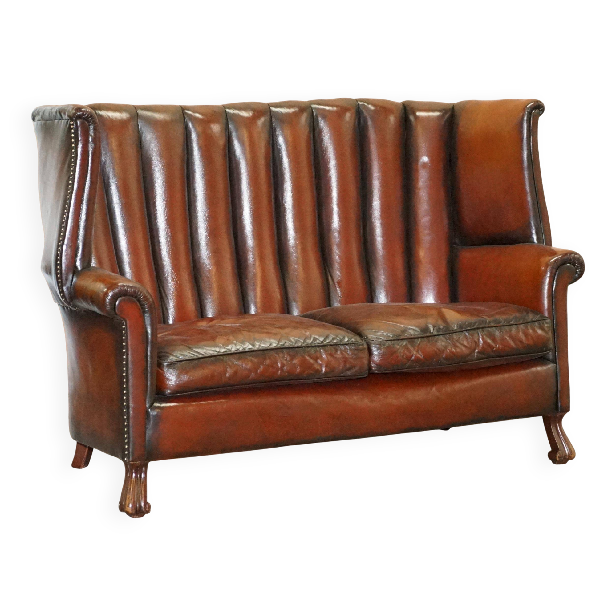 Victorian leather canapé and armchair, barrel back, circa 1860, restored.