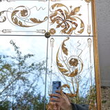 Glass mirror with a decoration engraved with golden foliage 1960