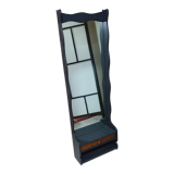 A renovated mirror in a wooden frame with a drawer and a shelf