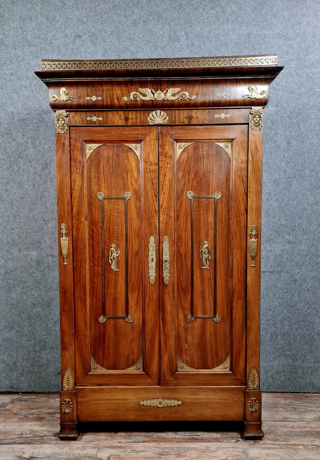 Louis Philippe period wardrobe (nineteenth) entirely covered with gilded bronzes