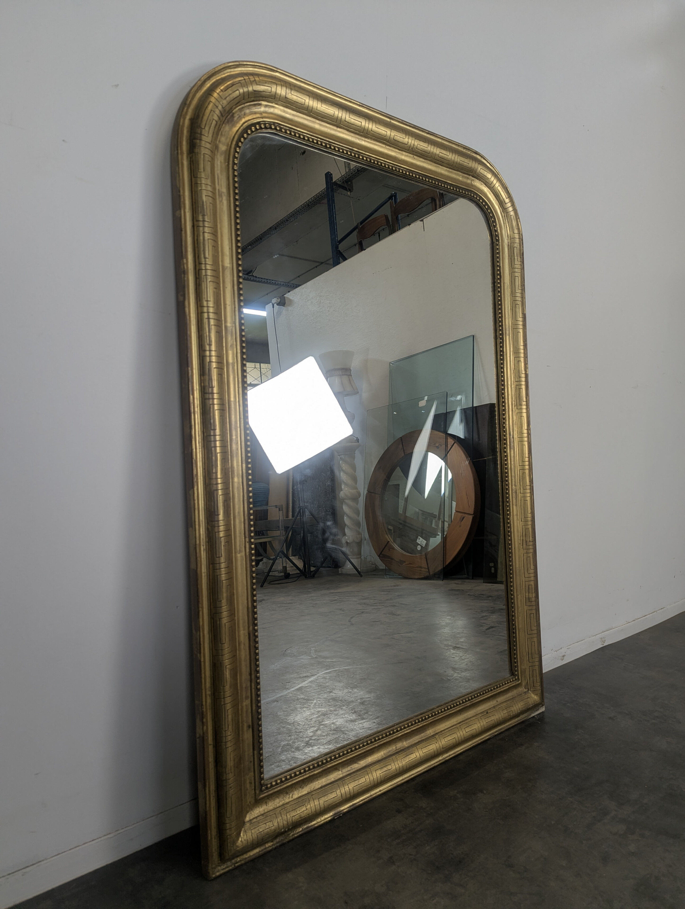 Golden wooden mirror with antique frieze from the Louis Philippe period.