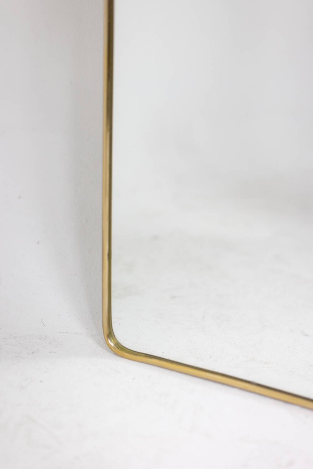Pair of narrow gilt brass mirrors. Circa 1970.