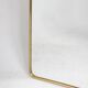 Pair of narrow gilt brass mirrors. Circa 1970.
