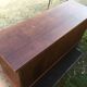 Low sideboard with sliding doors in waxed mahogany