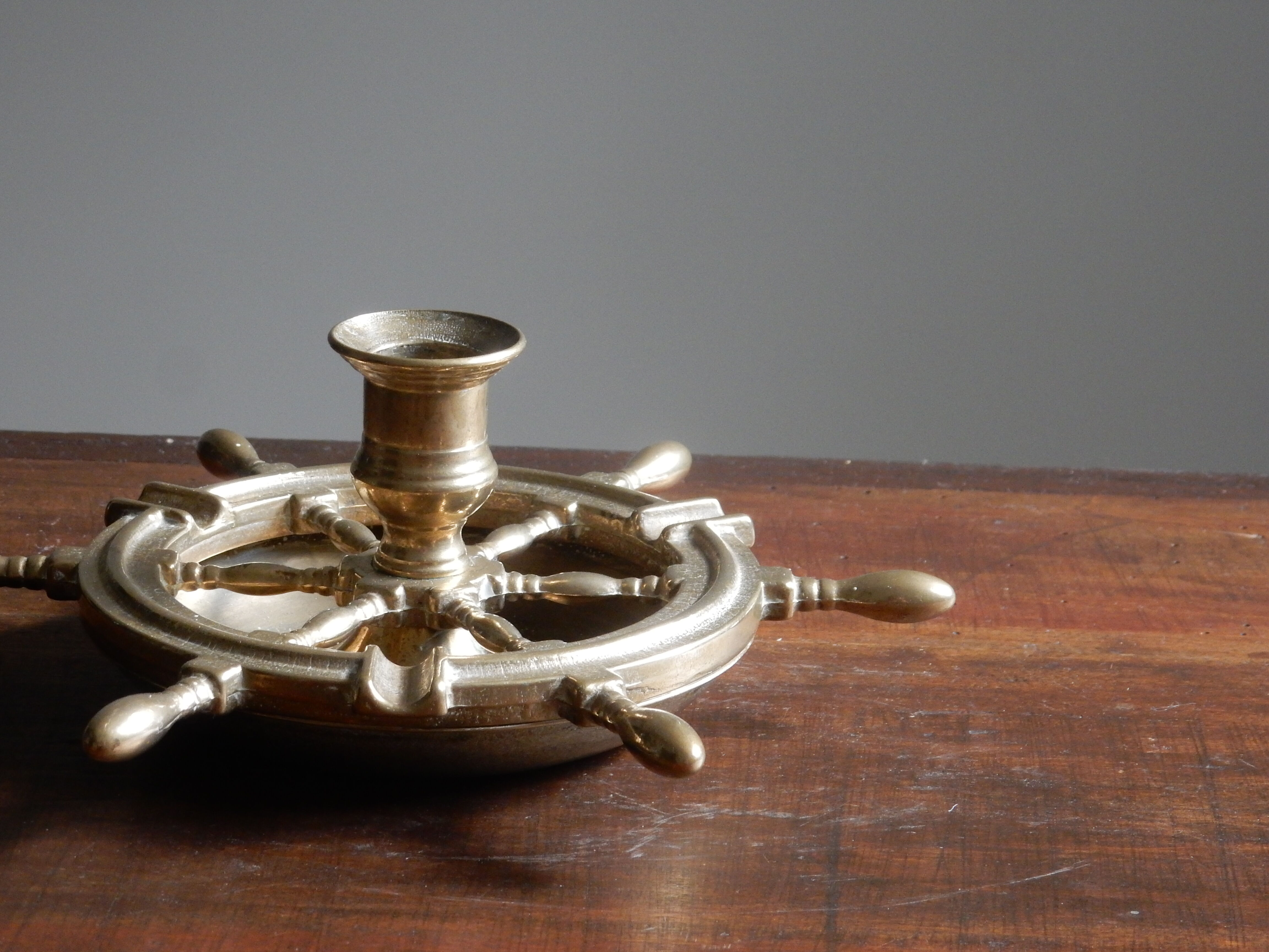 Brass ashtray and candlestick shaped boat bar