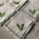 Series of four embroidered linen napkins