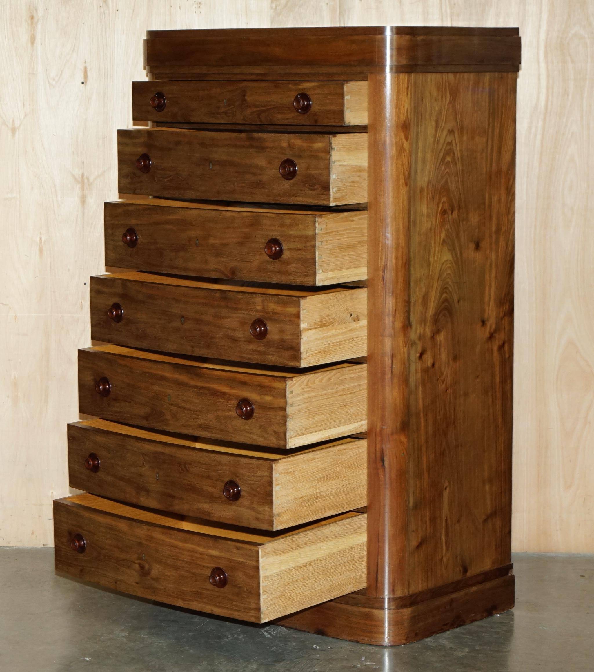 Pair of tall walnut chests of drawers with curved fronts in country style.