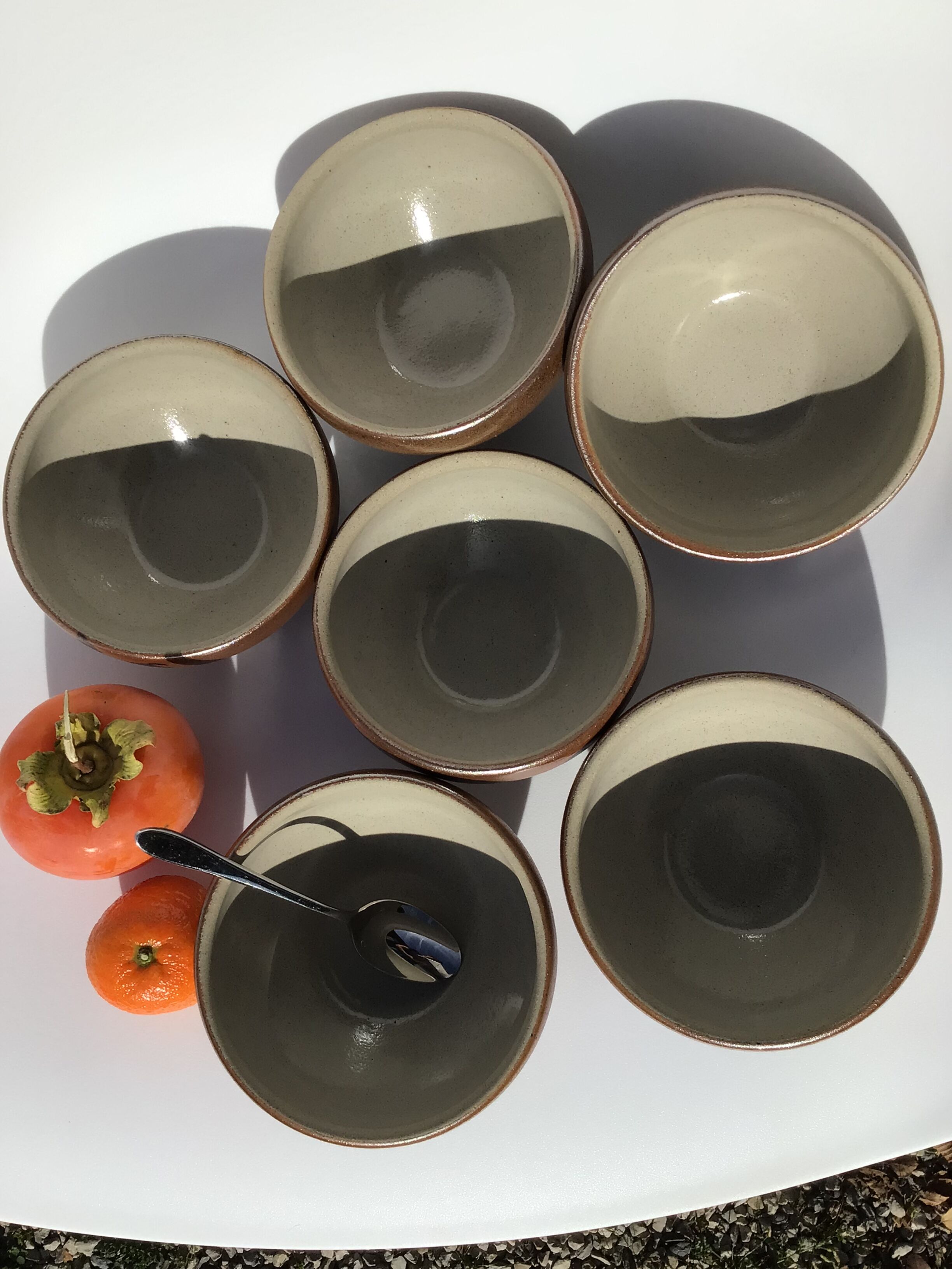 6 iridescent brown sandstone bowls inside grey