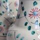 Pair of hand decorated enamelled ceramic vases, 13 cm