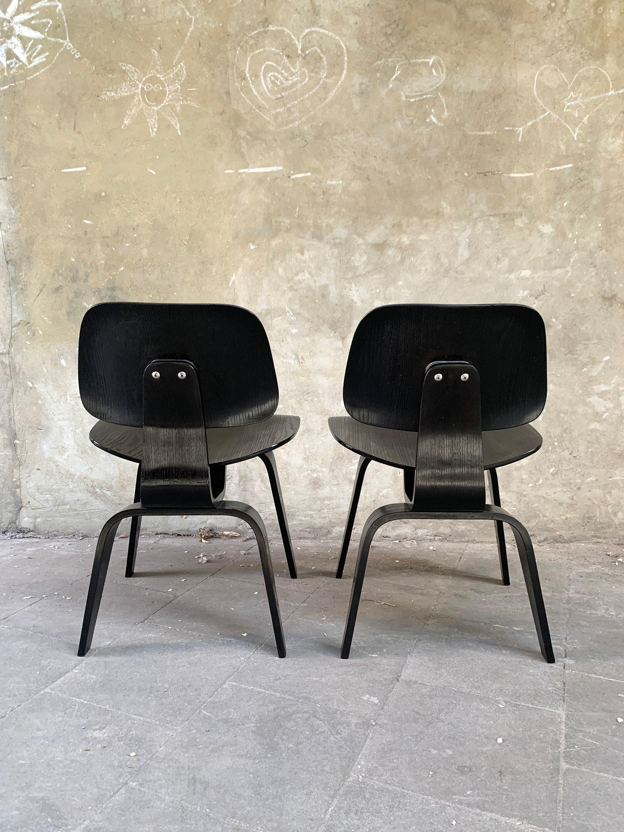 Pair of DCW chairs by Charles & Ray Eames in Black for Herman Miller 1950