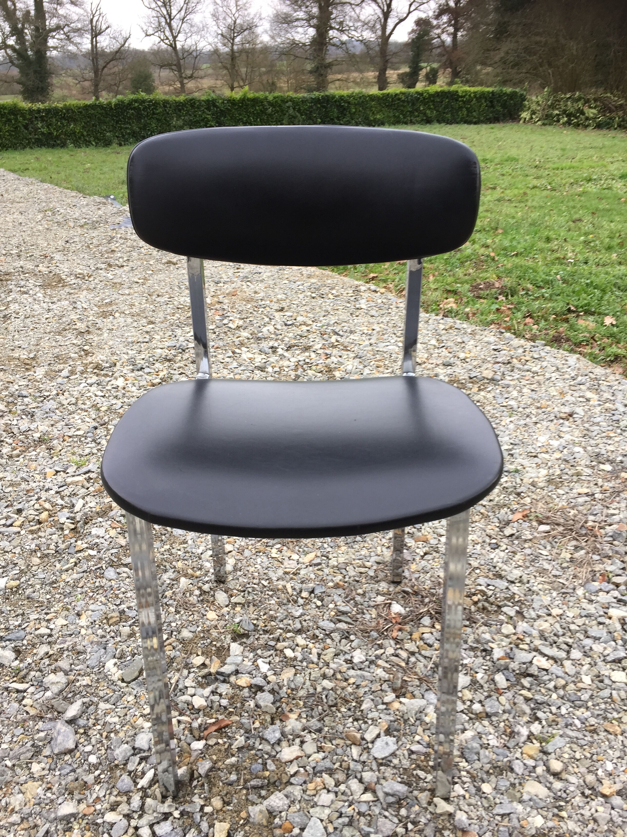 6 vintage chairs in black skaï with chrome metal tubular base.