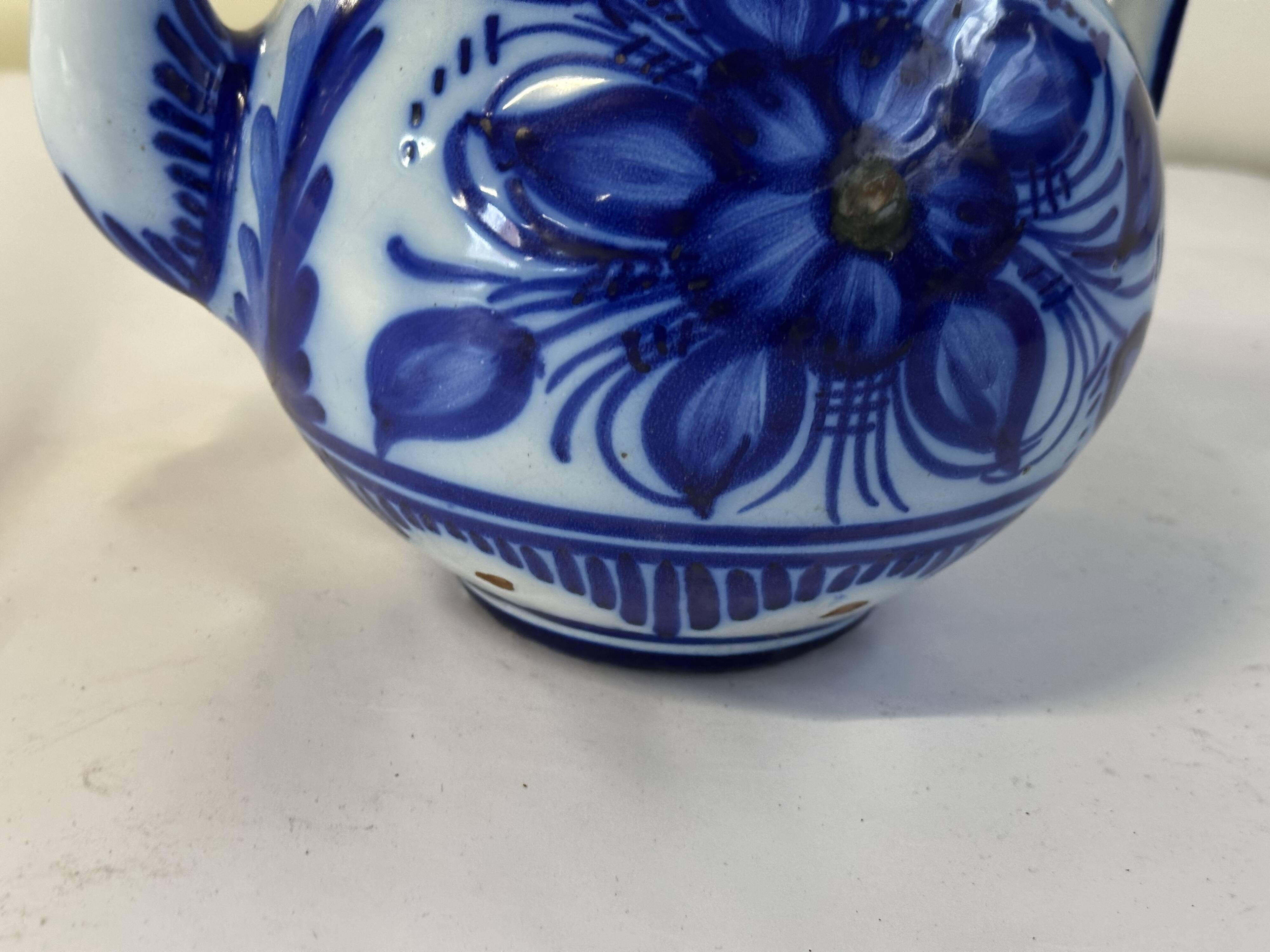 Glazed ceramic carafe with floral decoration