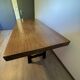 Industrial style table with a mahogany top.