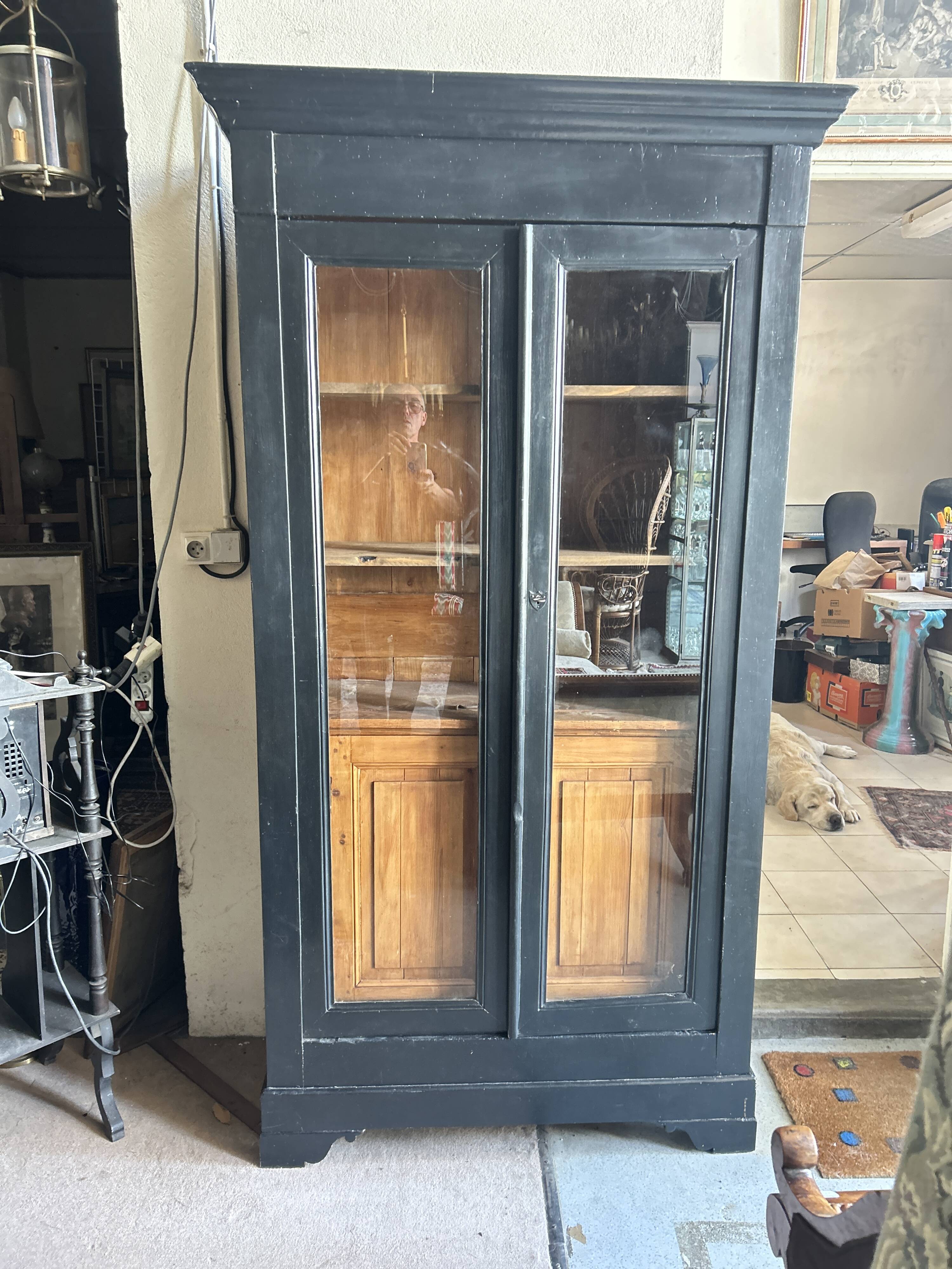 Black painted wardrobe with two glass doors and an interior sideboard.