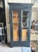 Black painted wardrobe with two glass doors and an interior sideboard.