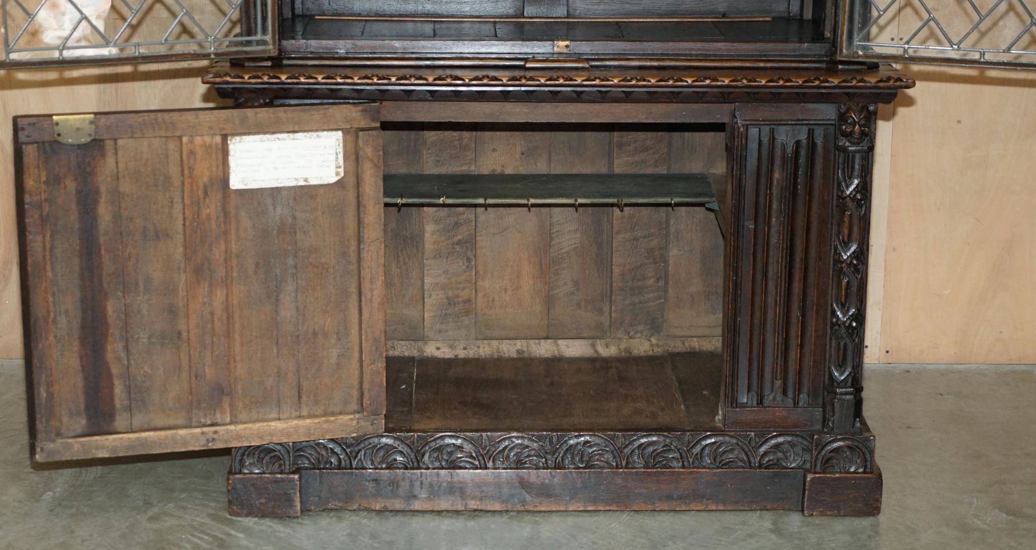 Jacobean hardwood library with carved panels and glass doors.