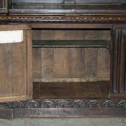 Jacobean hardwood library with carved panels and glass doors.