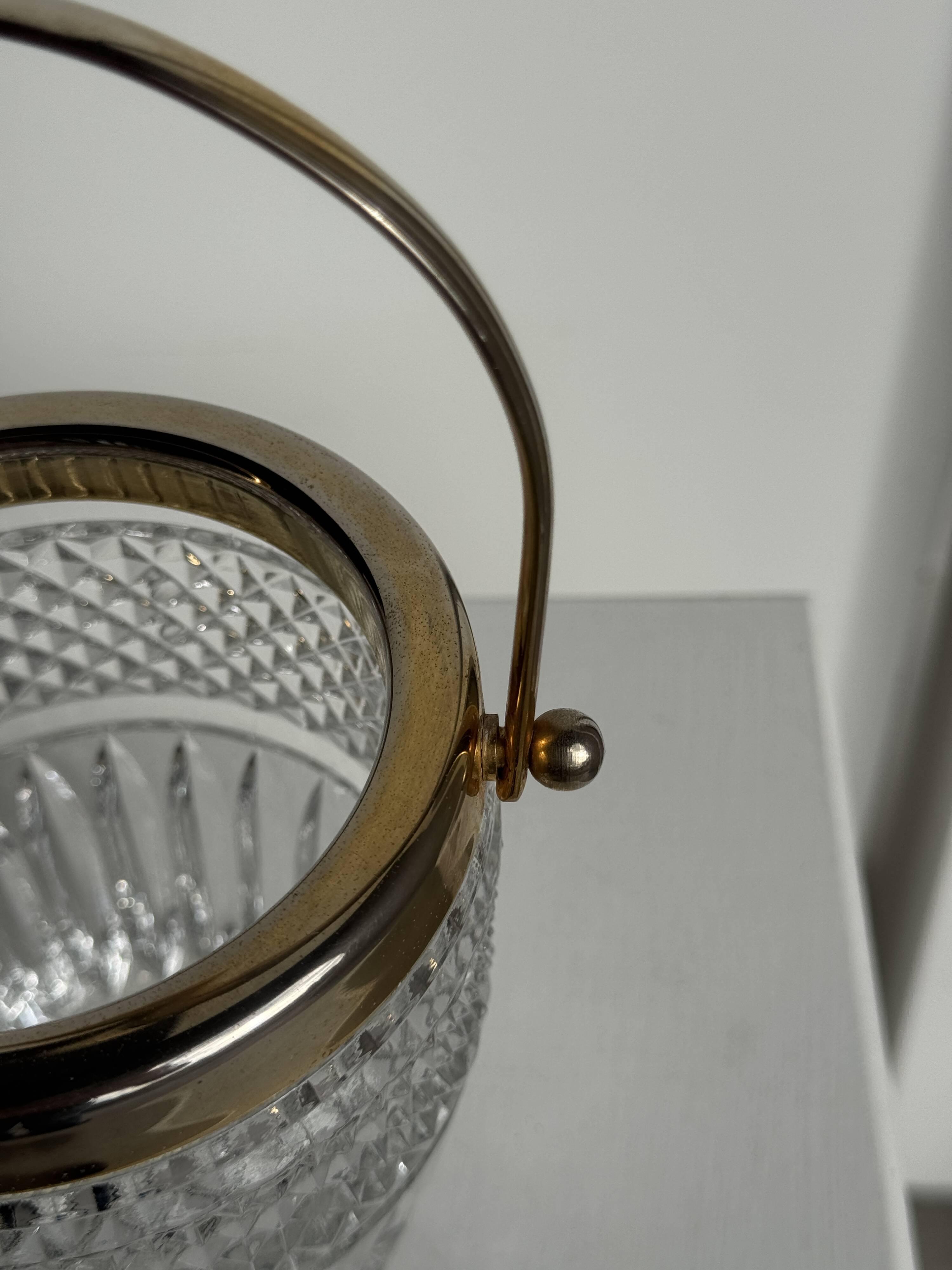 Small golden glass ice bucket with diamond point design and its scoop.