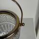Small golden glass ice bucket with diamond point design and its scoop.