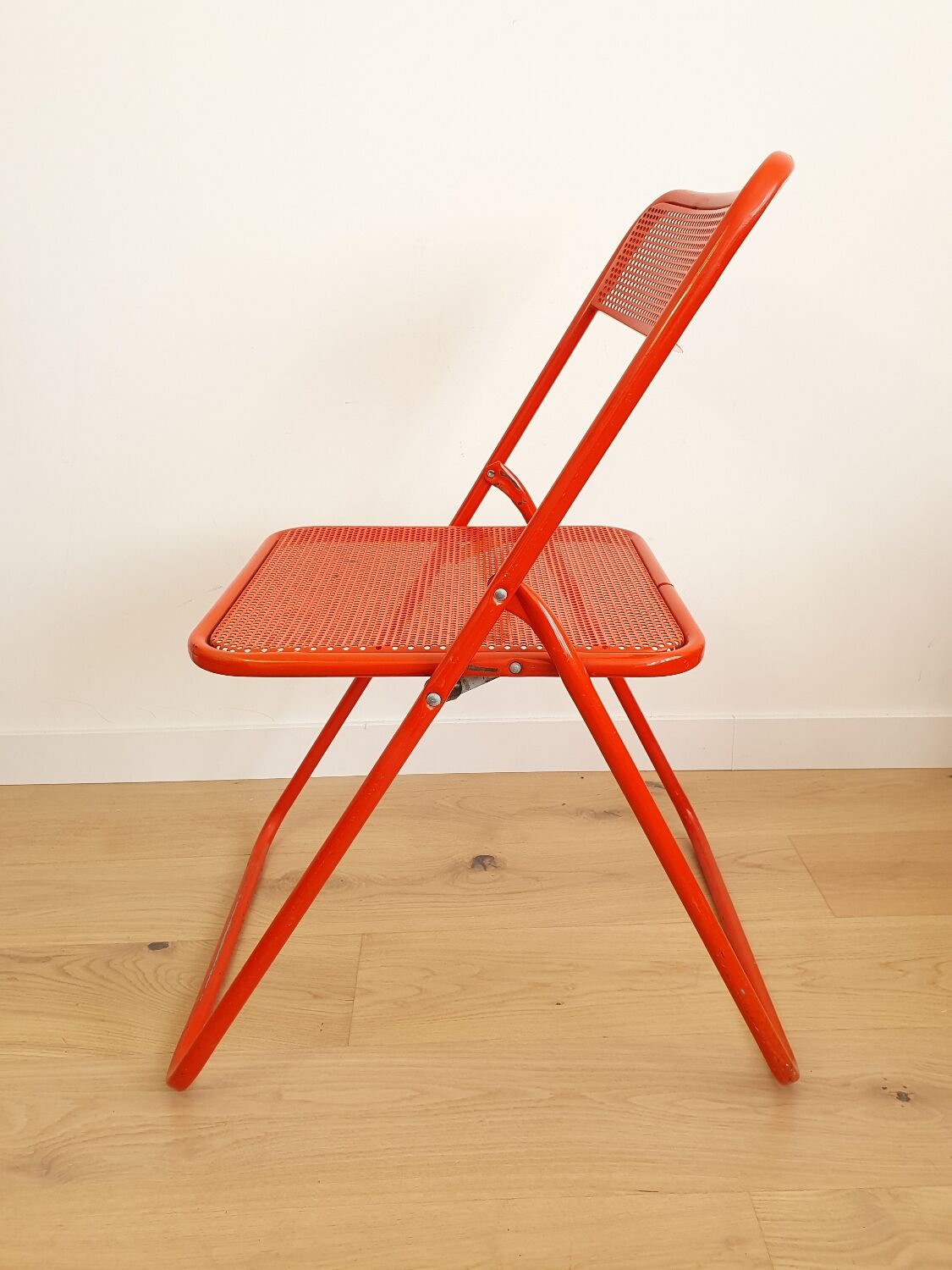 Perforated metal folding chair