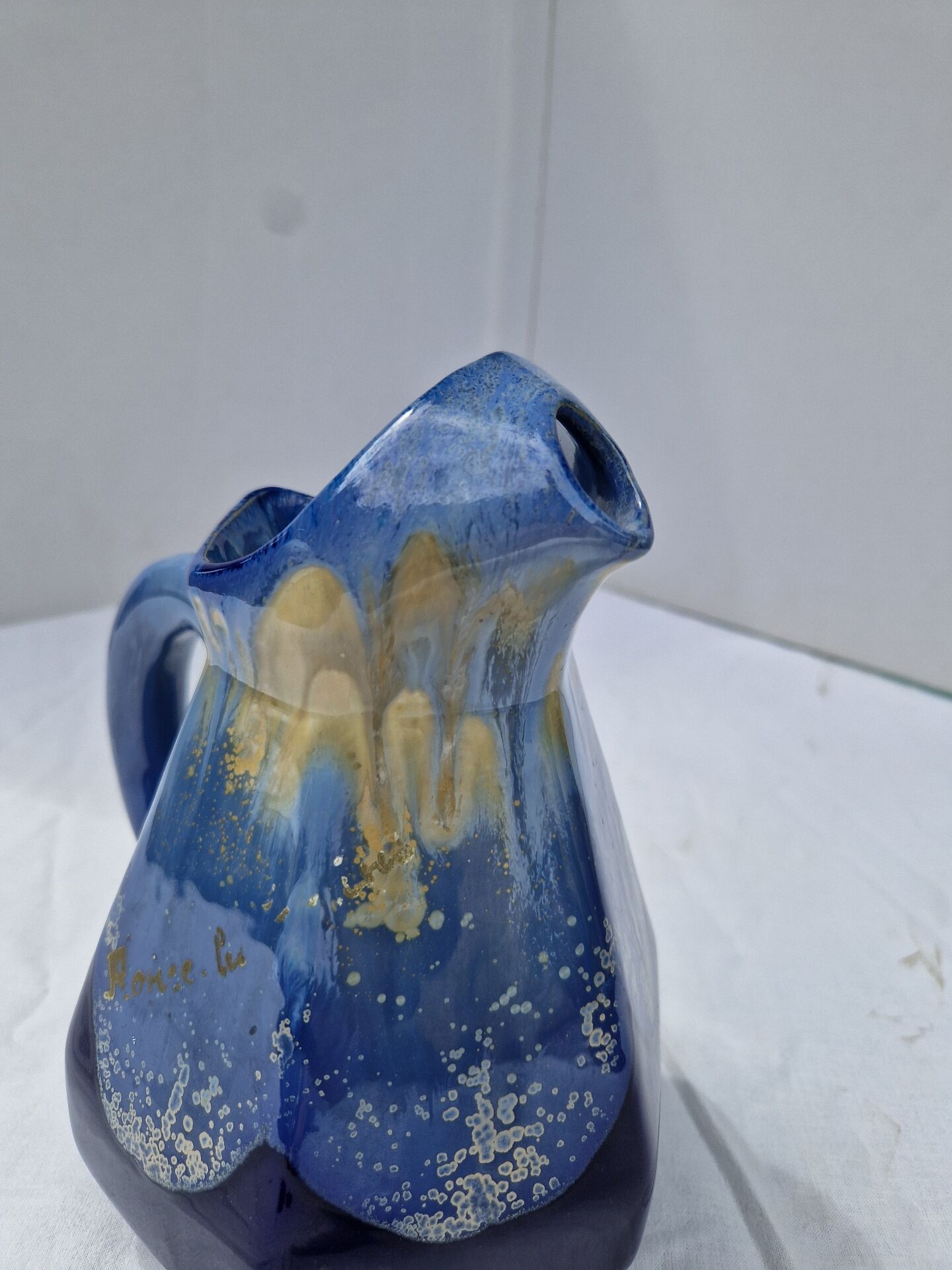 Old flamed ceramic jug. Very beautiful shades of blue, 6 sides.
