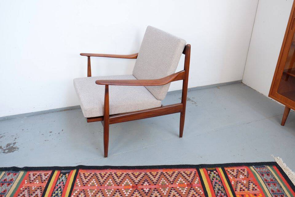Vintage teak lounge chair, retro 1960s–70s style.