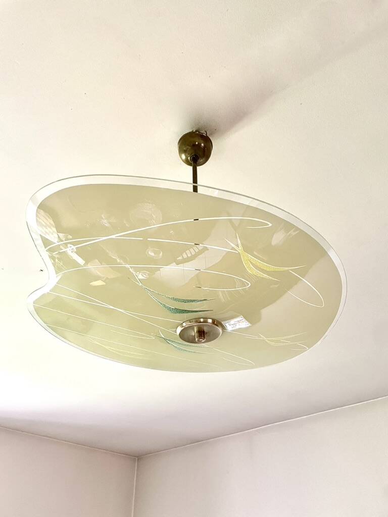 Pale yellow asymmetrical suspension cup 1960