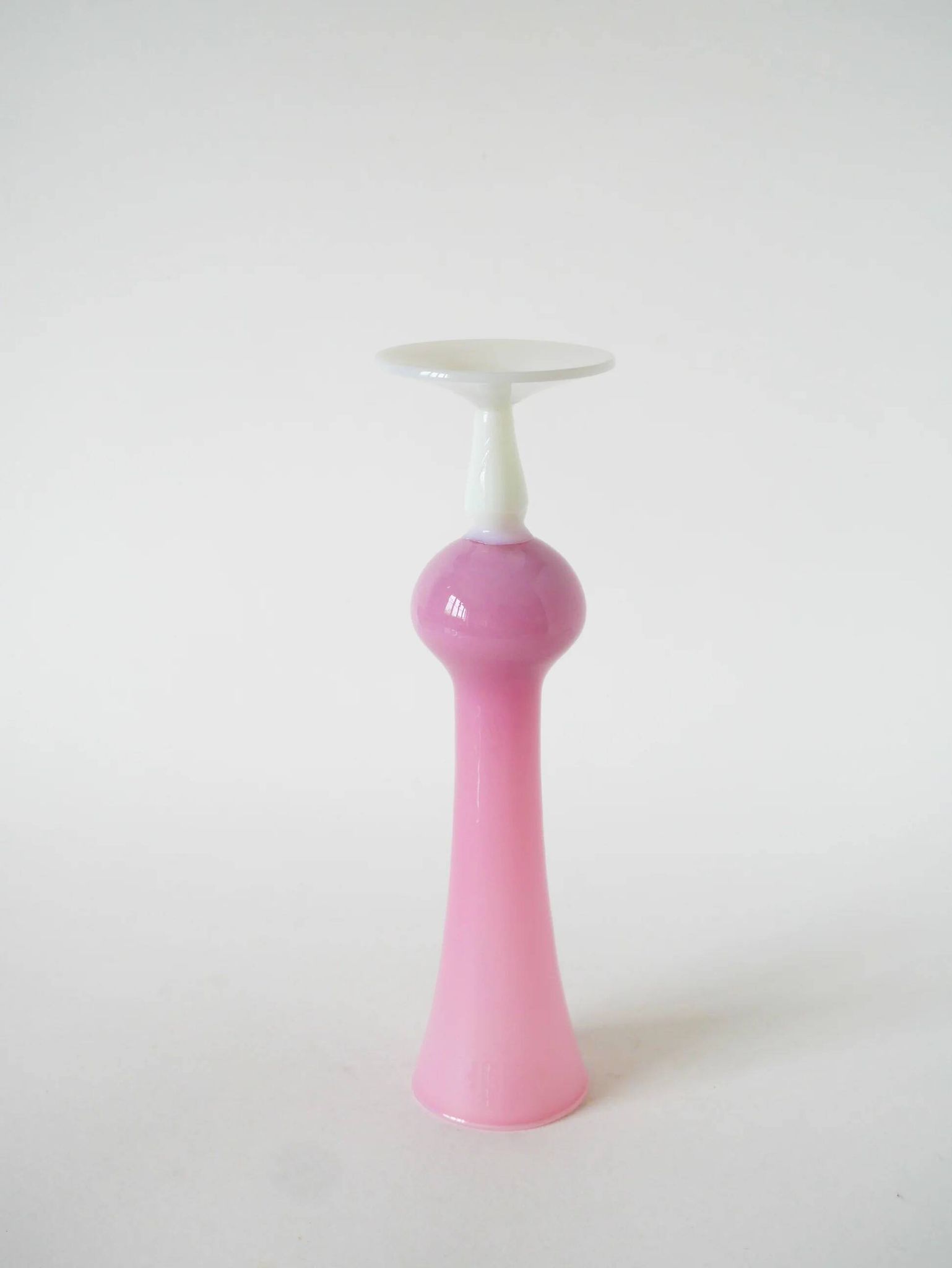 Single flower vase in opaline, pink with white feet, 1970.