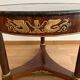 Empire gueridon in mahogany veneer adorned with chiselled and gilded bronze, topped with black marble with a groove.