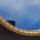 Oval mirror in gold metal
