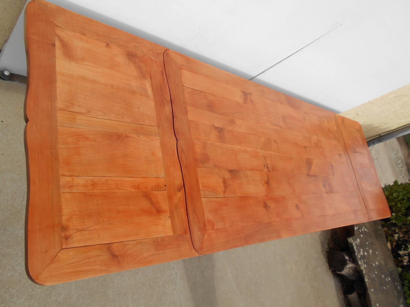 Large solid wood table with integrated extensions.