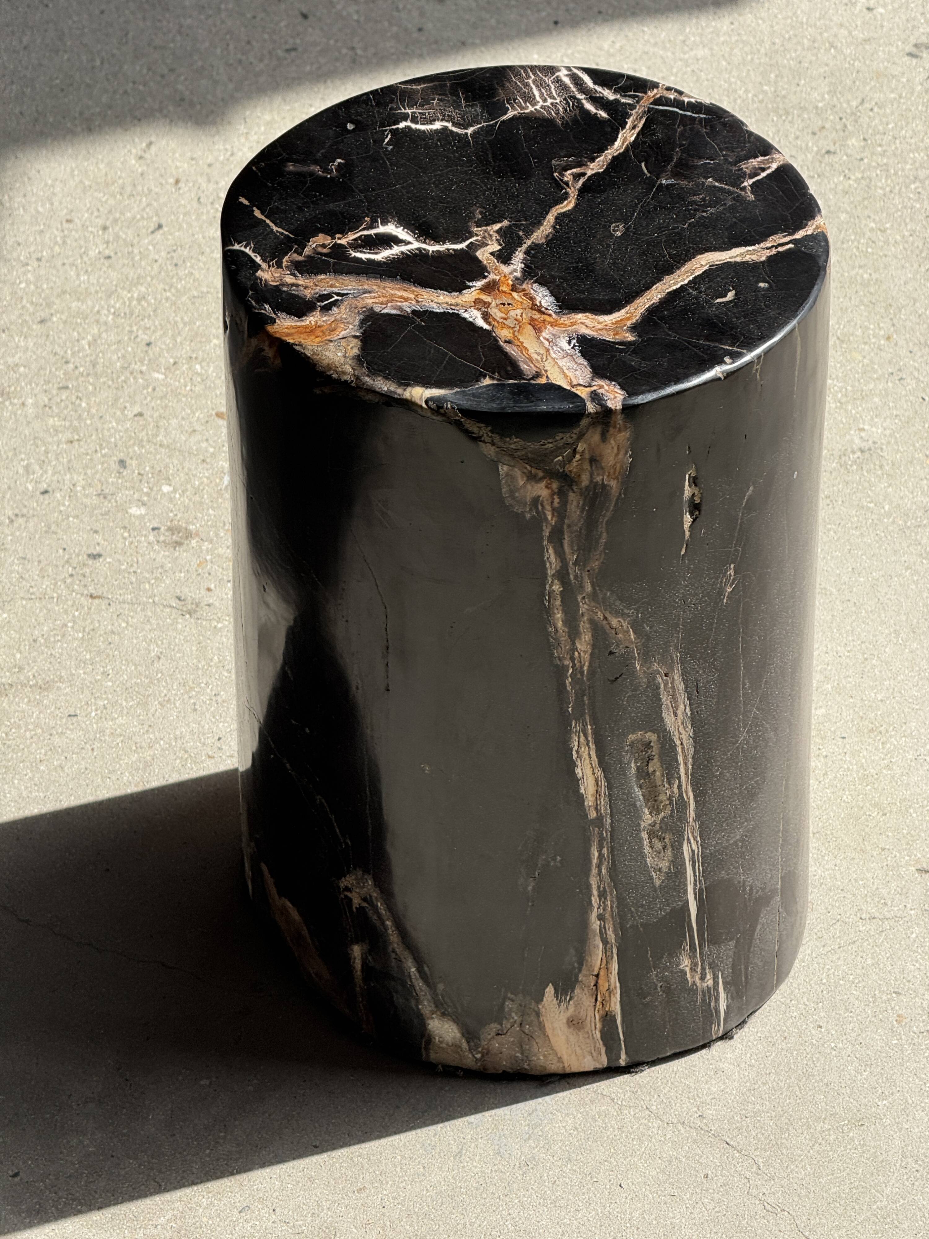 Black petrified wood side table with beige stripes, star pattern H35 D24.