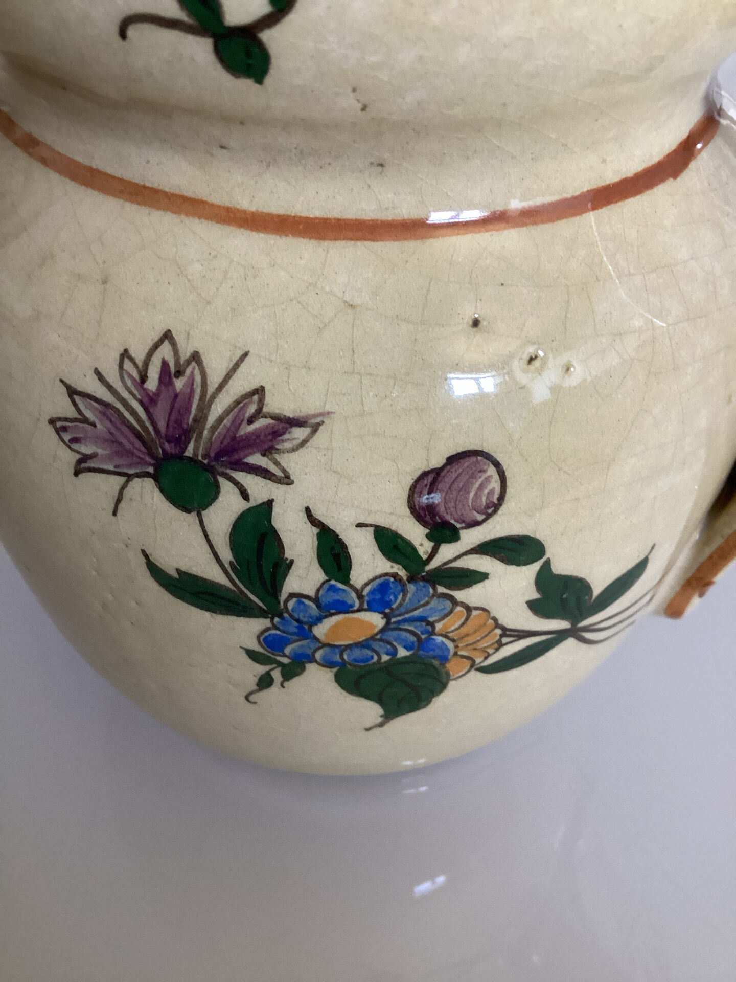 Old ceramic jug with floral decoration