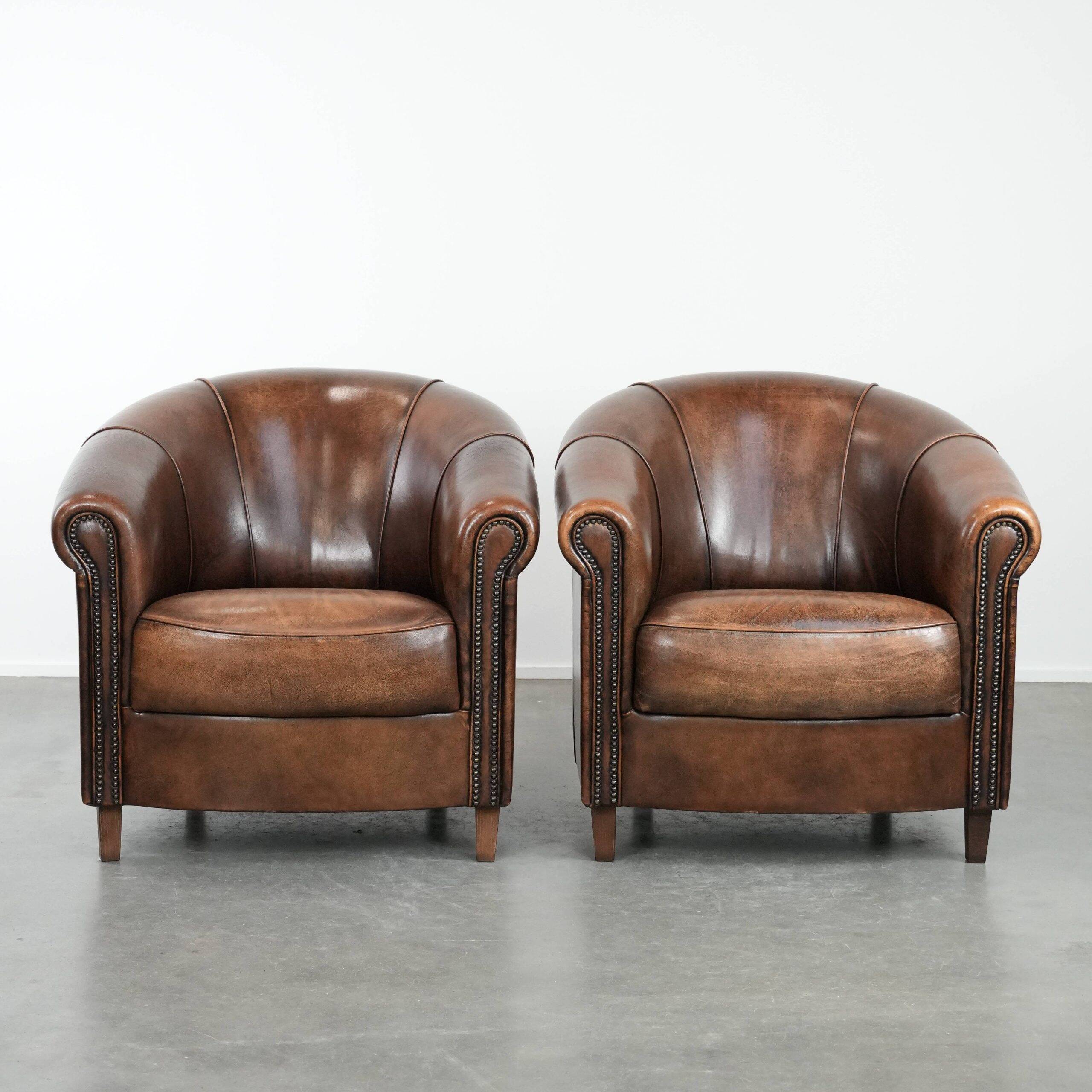Set of two sheepskin club armchairs with fixed seat cushions