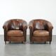 Set of two sheepskin club armchairs with fixed seat cushions