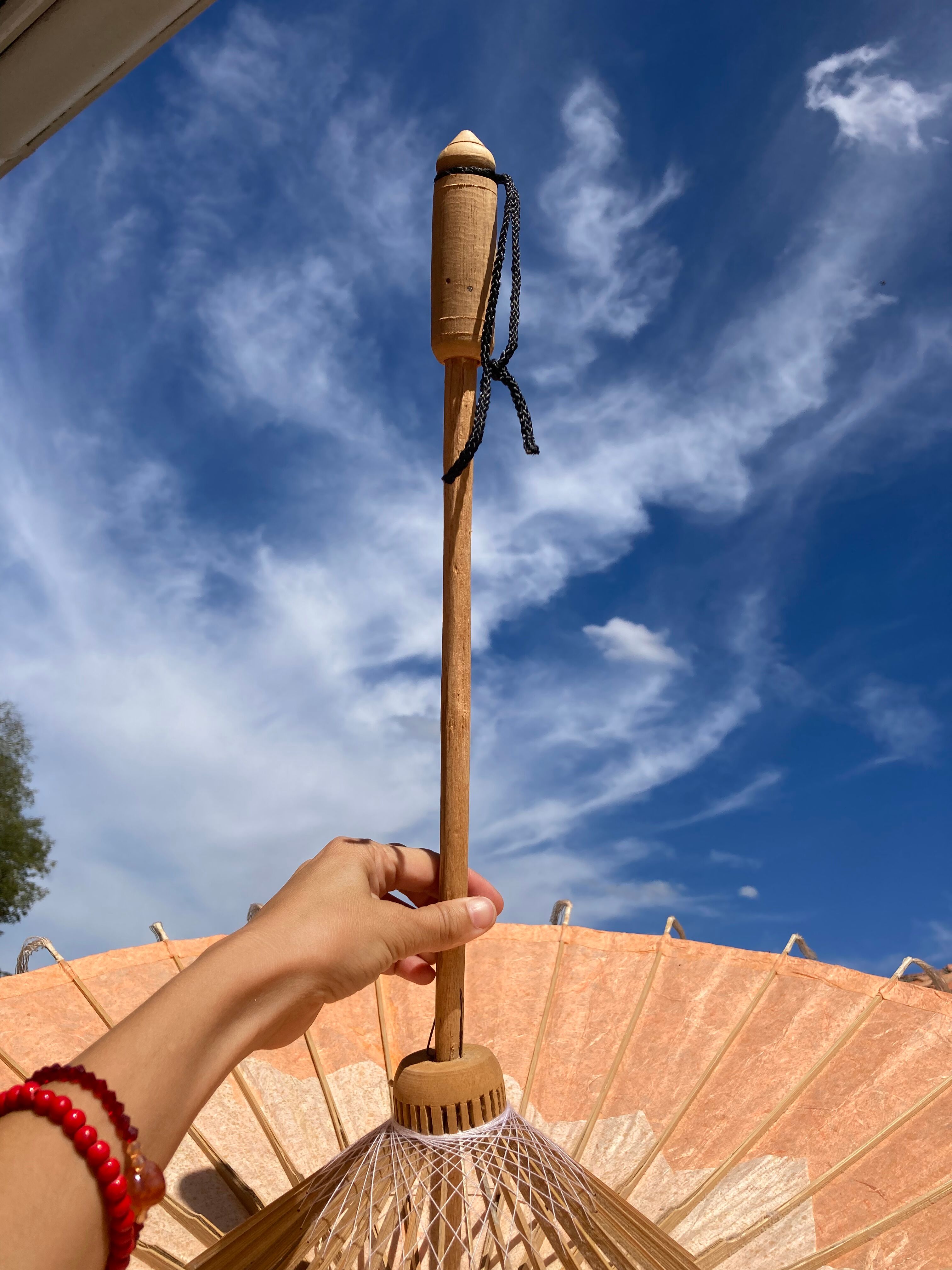 Powder pink paper umbrella and wooden handle
