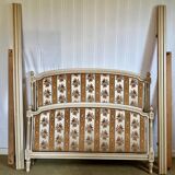 Louis XVI style bed in patinated wood with fluted columns.