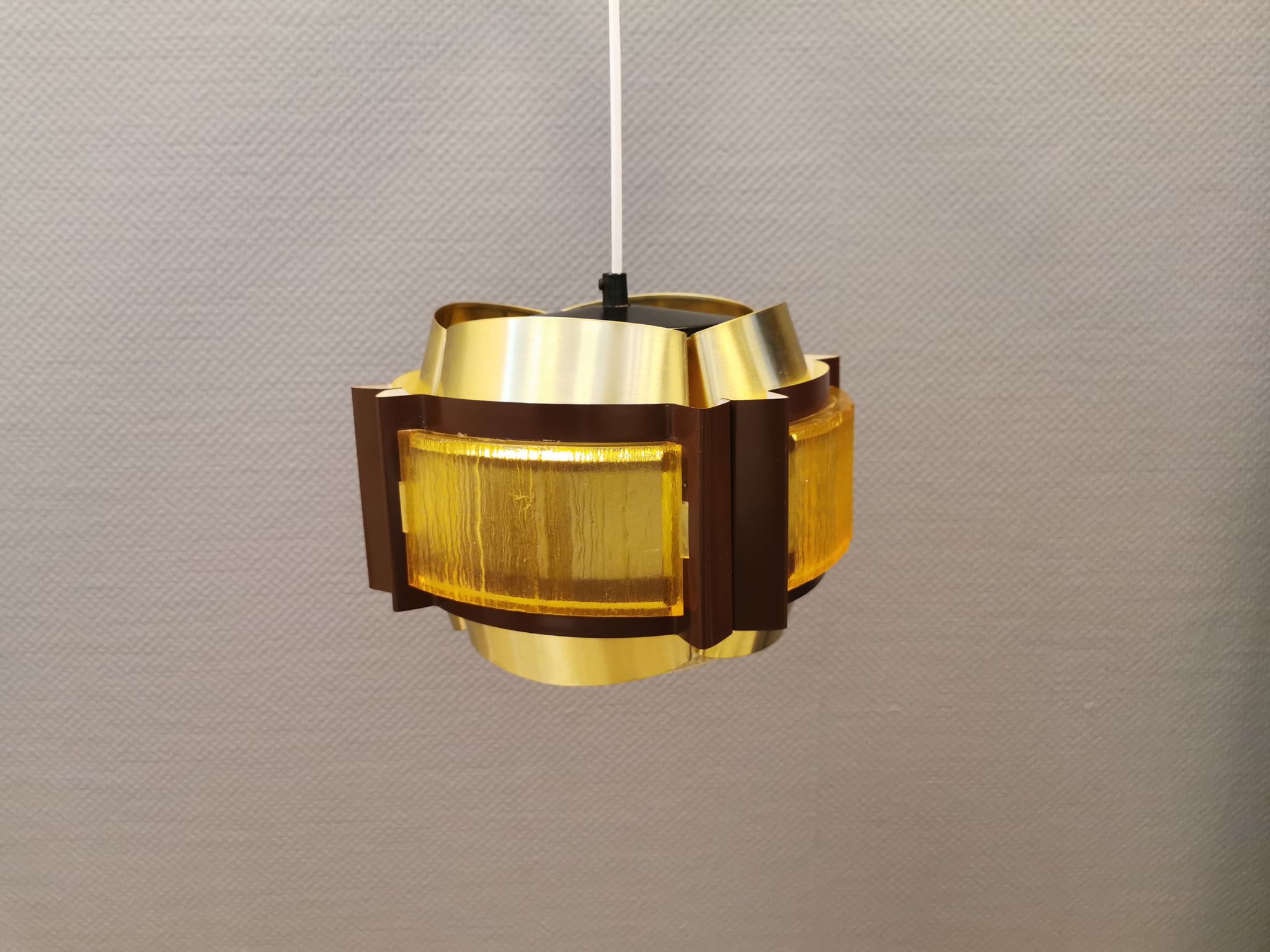 Danish hanging lamp, made in brass colored and brown metal, with yellowish hard pressed plastic deta