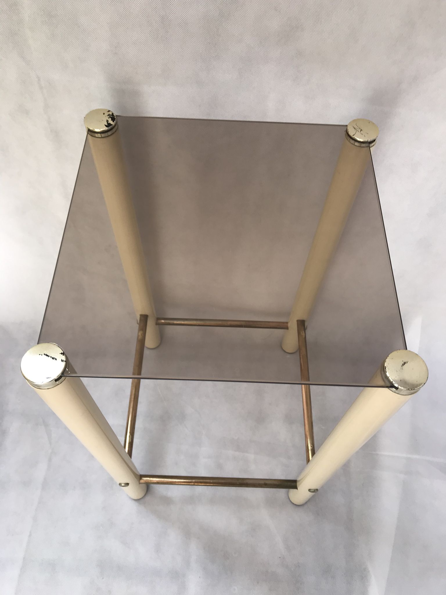Square side table in metal and smoked glass.
