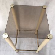 Square side table in metal and smoked glass.