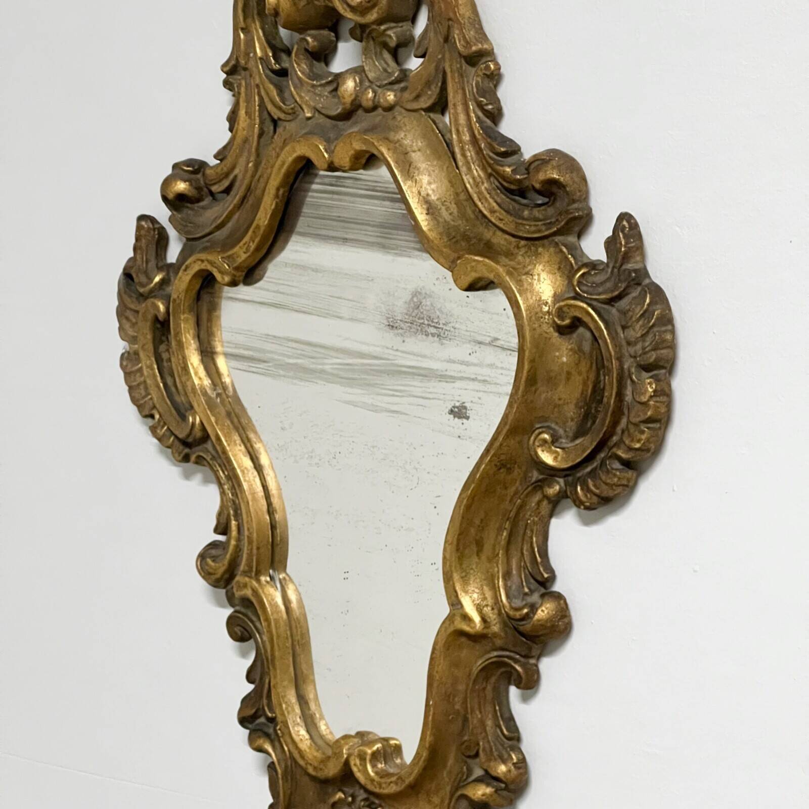 Pair of mirrors in wood decorated with gold leaf.