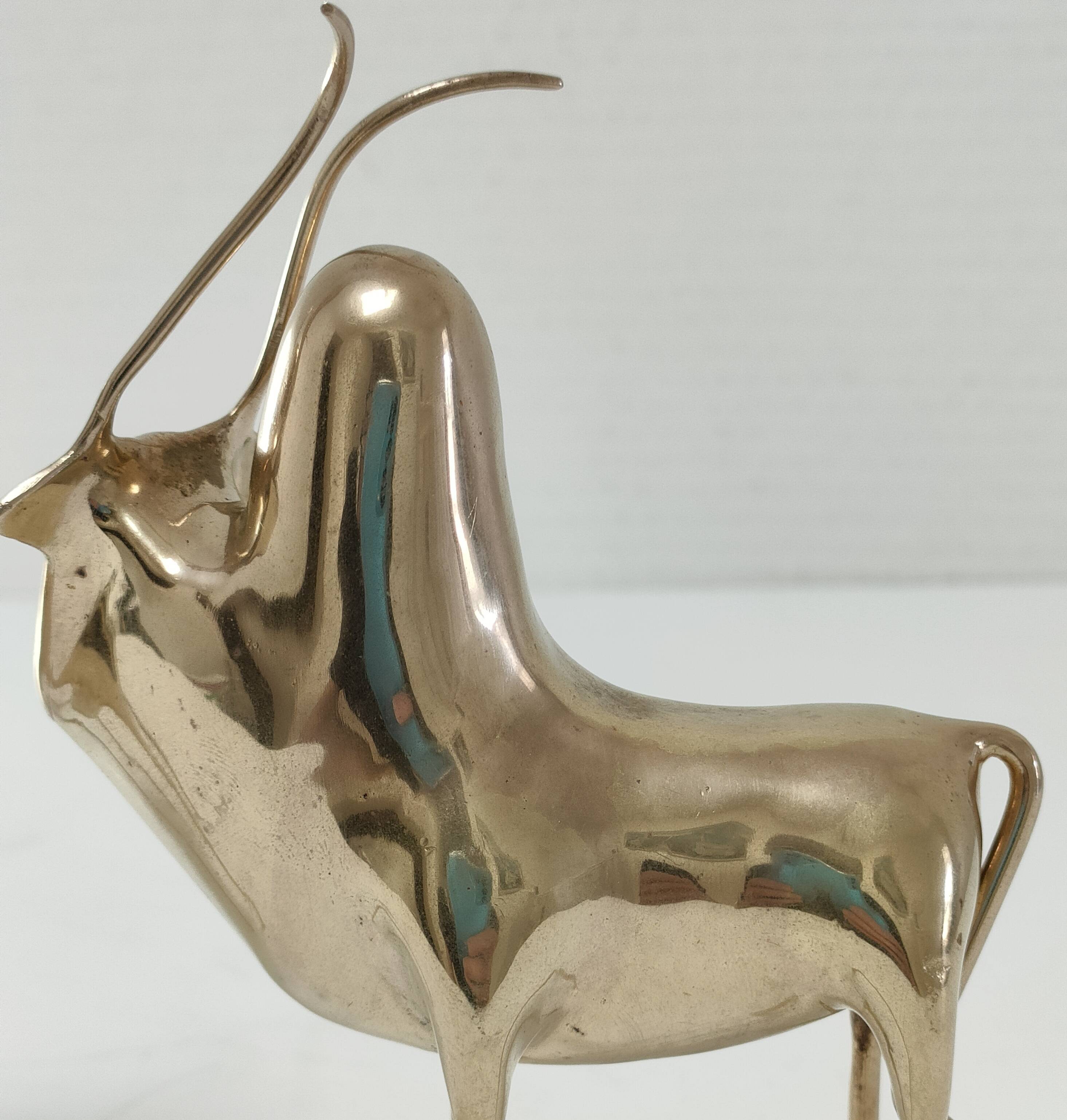Two stylized zebu with long vintage brass horns