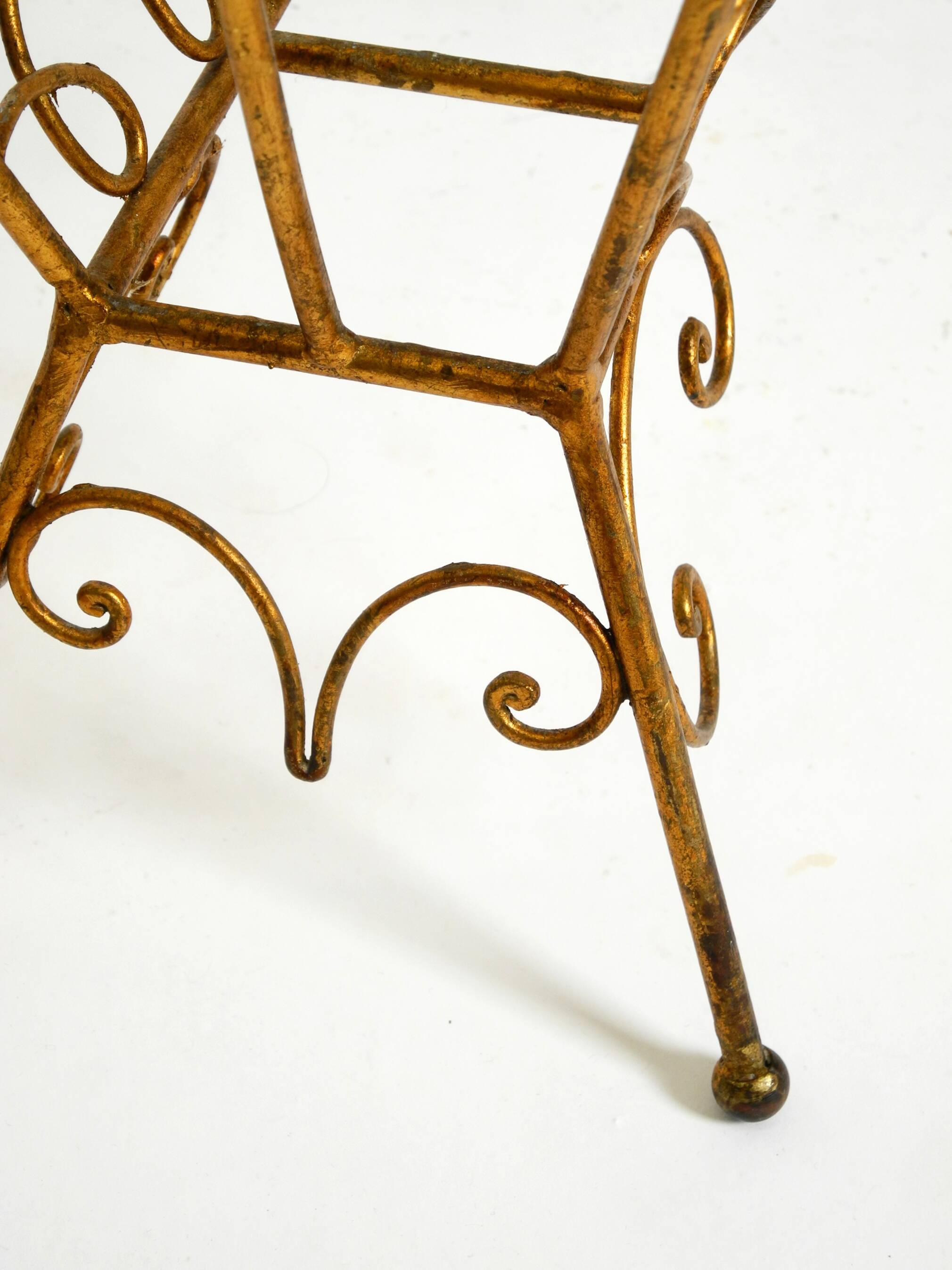 Extraordinary mid-century newspaper and magazine rack with a gilded metal