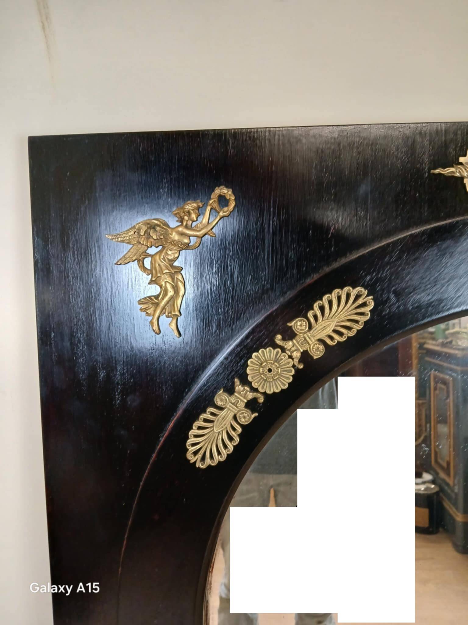 Miroir Empire en bois laqué noir et bronze doré époque XIXeme
