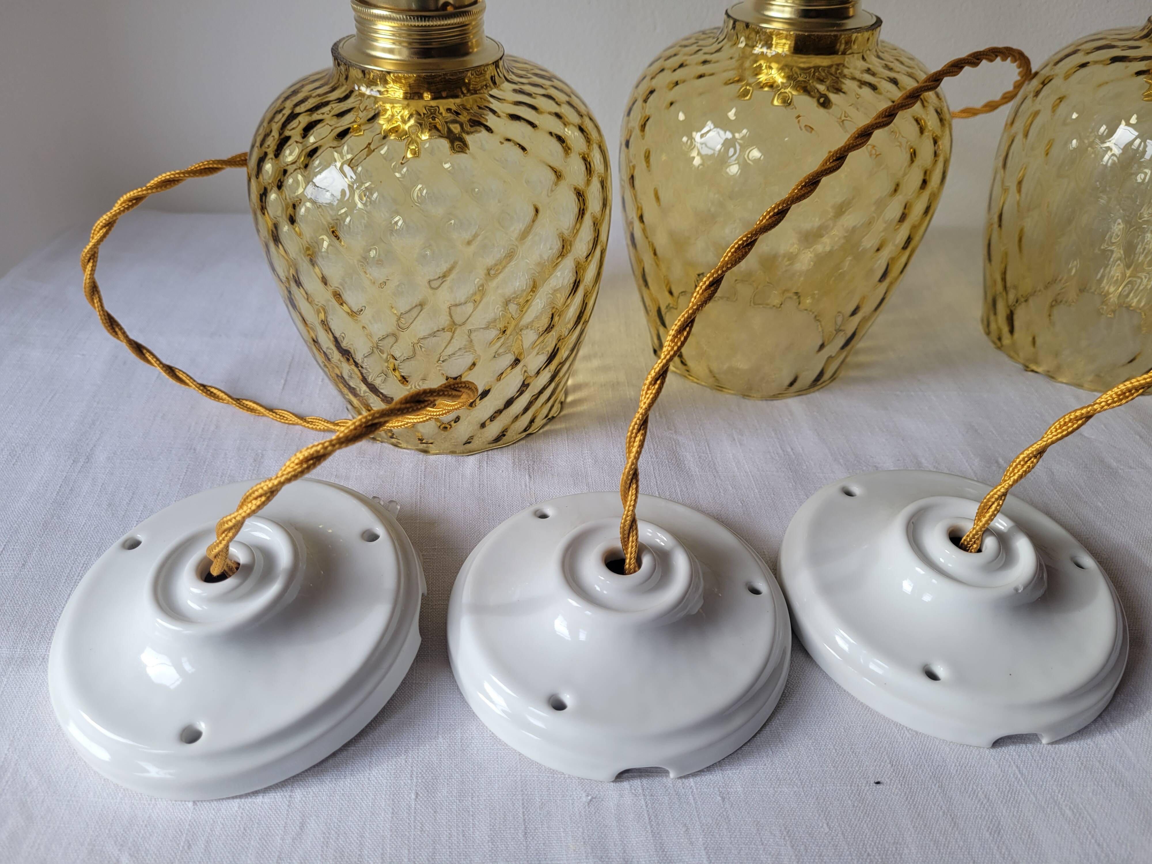 Trio of yellow glass pendant lights