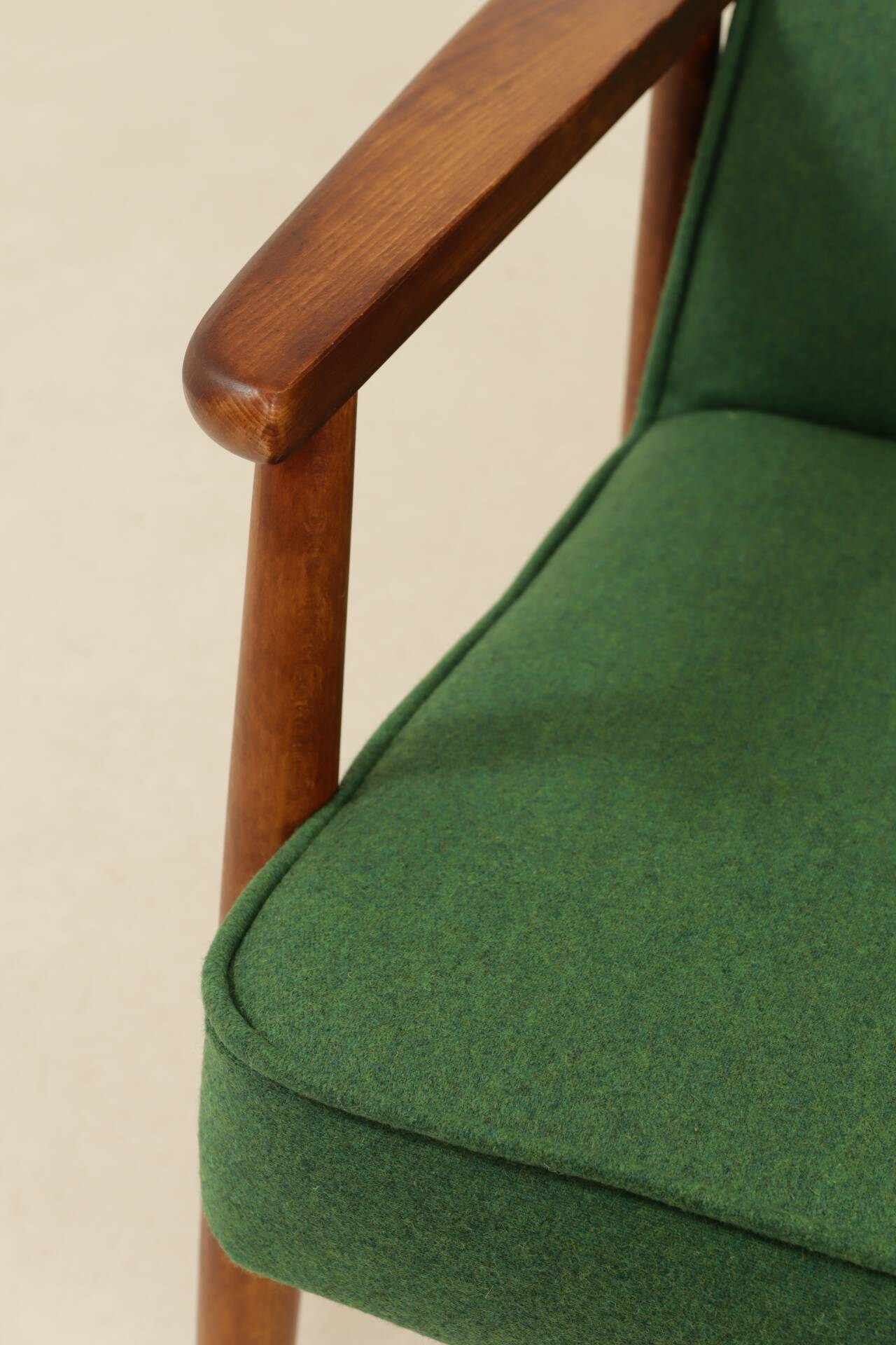 Scandinavian modern chair in green wool, vintage wooden armchair.