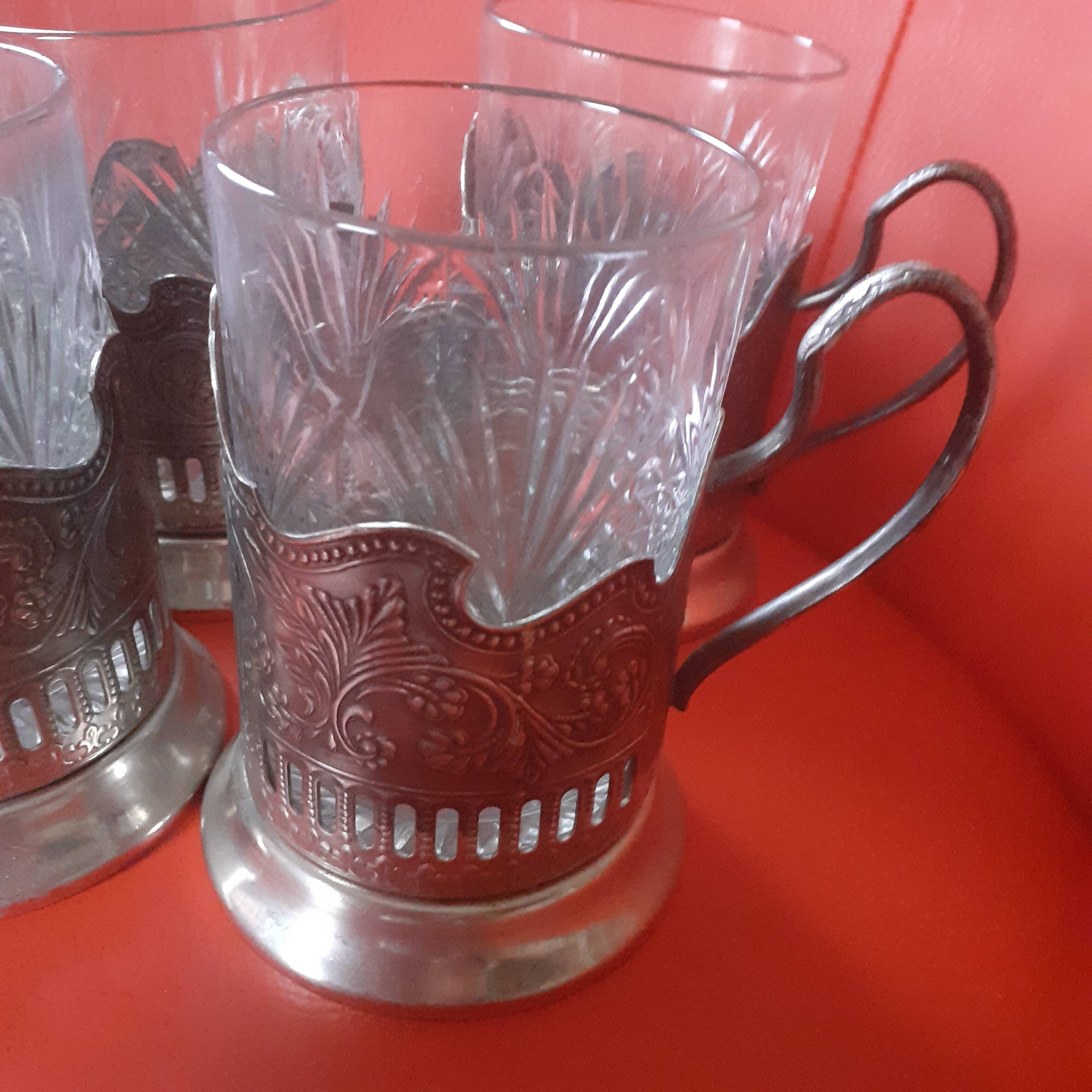 4 glasses engraved on their silver metal support;